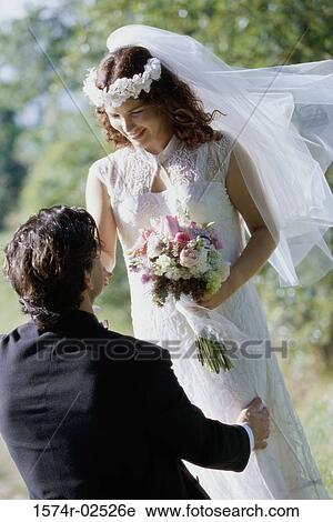 High angle view of a groom kissing his bride's hand View Large Photo Image Stock Image - High angle view of a groom kissing his bride's hand. Fotosearch