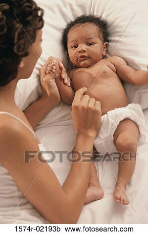 High angle view of a mother playing with her baby boy View Large Photo Image Stock Image - High angle view of a mother playing with her baby boy. Fotosearch