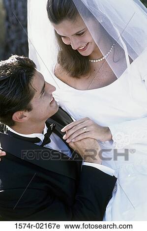 Stock Image - High angle view of a newlywed couple looking at each other. Fotosearch