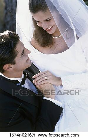 High angle view of a newlywed couple looking at each other View Large Photo Image Stock Image - High angle view of a newlywed couple looking at each other. Fotosearch