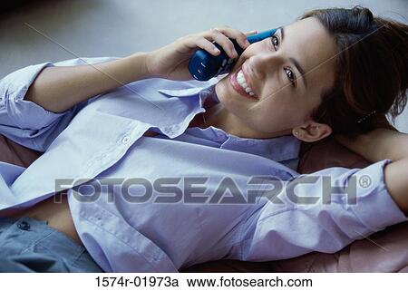 Stock Image - High angle view of a teenage girl talking on a cordless phone. Fotosearch