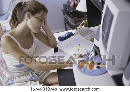 Stock Image - High angle view of a teenage girl studying. Fotosearch