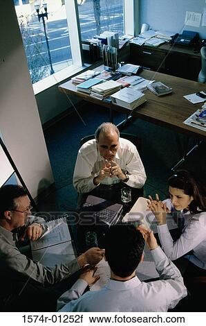 Stock Image - High angle view of business executives in a meeting. Fotosearch