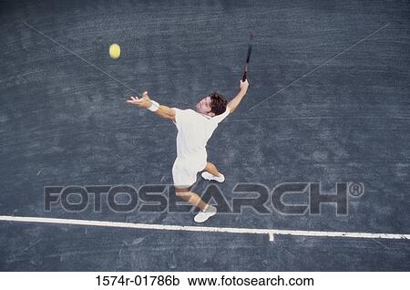 High angle view of man serving a tennis ball View Large Photo Image Stock Image - High angle view of man serving a tennis ball. Fotosearch