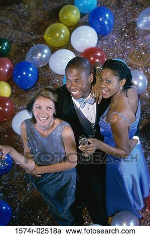 High angle view of two young women with a young man at a party View Large Photo Image Stock Image - High angle view of two young women with a young man at a party. Fotosearch