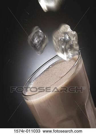 Ice cubes falling into a glass of chocolate milk View Large Photo Image Stock Image - Ice cubes falling into a glass of chocolate milk. Fotosearch