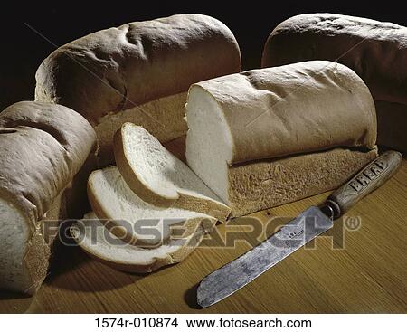 Picture - Loaves of bread and a knife. Fotosearch