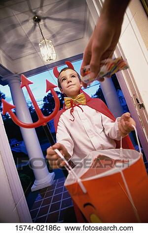 Low angle view of a boy dressed as the devil on Halloween View Large Photo Image Stock Image - Low angle view of a boy dressed as the devil on Halloween. Fotosearch