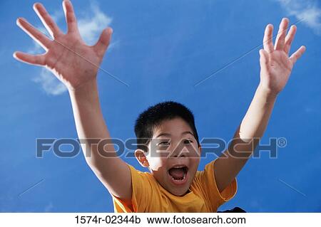 Low angle view of a boy with his arms outstretched View Large Photo Image Stock Image - Low angle view of a boy with his arms outstretched. Fotosearch