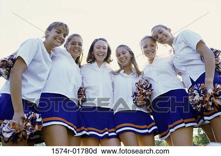 Low angle view of a group of cheerleaders smiling View Large Photo Image Stock Image - Low angle view of a group of cheerleaders smiling. Fotosearch