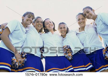 Low angle view of a group of cheerleaders smiling View Large Photo Image Stock Image - Low angle view of a group of cheerleaders smiling. Fotosearch