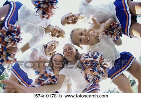 Low angle view of a group of cheerleaders smiling View Large Photo Image Stock Image - Low angle view of a group of cheerleaders smiling. Fotosearch