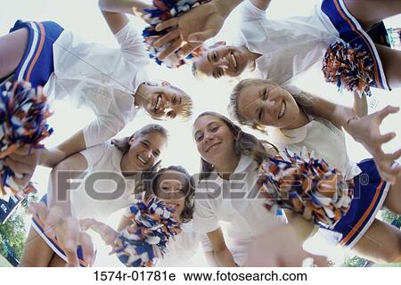 Low angle view of a group of cheerleaders smiling View Large Photo Image Stock Image - Low angle view of a group of cheerleaders smiling. Fotosearch