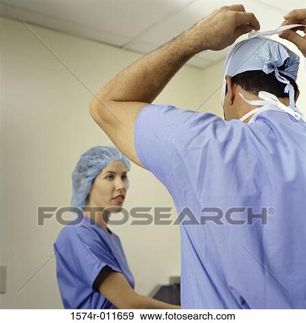 Stock Photo - Low angle view of a male and female surgeon. Fotosearch