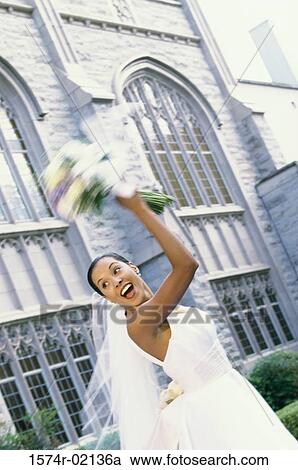 Low angle view of a newlywed young woman tossing the bouquet View Large Photo Image Stock Image - Low angle view of a newlywed young woman tossing the bouquet. Fotosearch