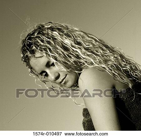 Stock Photo - Low angle view of a young woman looking down. Fotosearch