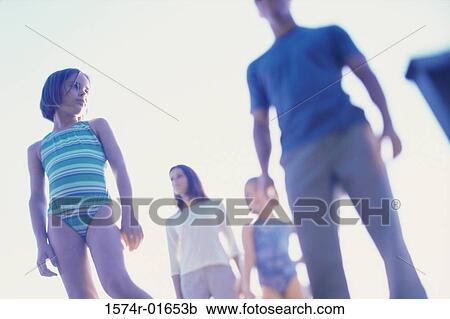 Stock Image - Low angle view of parents with their two daughters. Fotosearch