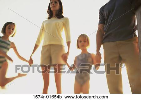 Low angle view of parents with their two daughters View Large Photo Image Stock Image - Low angle view of parents with their two daughters. Fotosearch