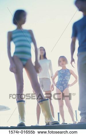 Stock Image - Low angle view of parents with their two daughters. Fotosearch