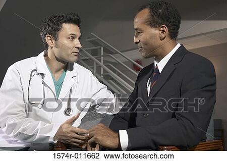 Male doctor talking to a male patient View Large Photo Image Stock Image - Male doctor talking to a male patient. Fotosearch