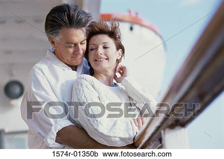 Mature couple holding each other on a cruise ship View Large Photo Image Stock Image - Mature couple holding each other on a cruise ship. Fotosearch