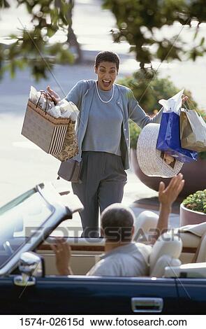 Mature woman carrying shopping bags View Large Photo Image Stock Image - Mature woman carrying shopping bags. Fotosearch