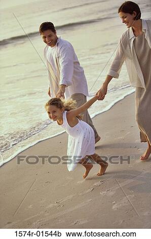 Stock Image - men, sand, tilt, up, smile, family, child. Fotosearch