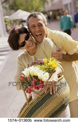 Mid adult couple holding each other View Large Photo Image Stock Image - Mid adult couple holding each other. Fotosearch
