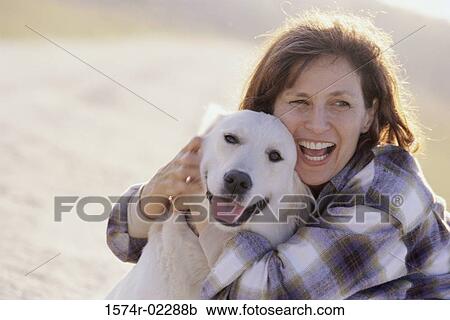 Mid adult woman holding her dog View Large Photo Image Stock Image - Mid adult woman holding her dog. Fotosearch