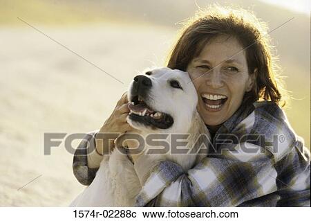 Mid adult woman holding her dog View Large Photo Image Stock Image - Mid adult woman holding her dog. Fotosearch