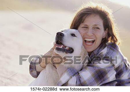 Mid adult woman holding her dog View Large Photo Image Stock Image - Mid adult woman holding her dog. Fotosearch