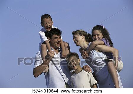Picture - Mother and father on the beach with their three children. Fotosearch
