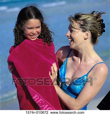 Mother and her daughter at the beach View Large Photo Image Stock Image - Mother and her daughter at the beach. Fotosearch