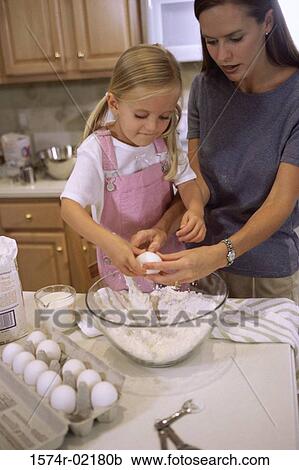 Stock Image - Mother and her daughter in the kitchen. Fotosearch