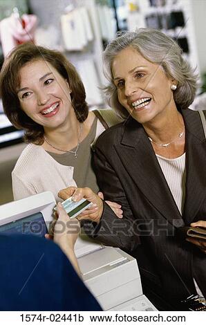 Mother and her daughter shopping in a store View Large Photo Image Stock Image - Mother and her daughter shopping in a store. Fotosearch