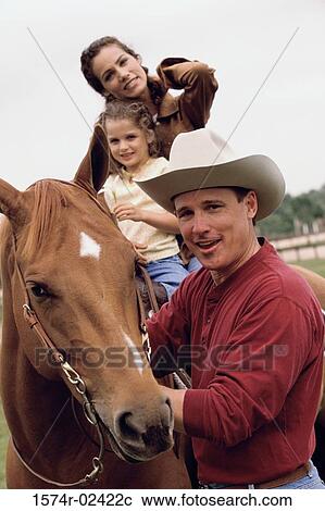 Mother and her daughter sitting on a horse View Large Photo Image Stock Image - Mother and her daughter sitting on a horse. Fotosearch