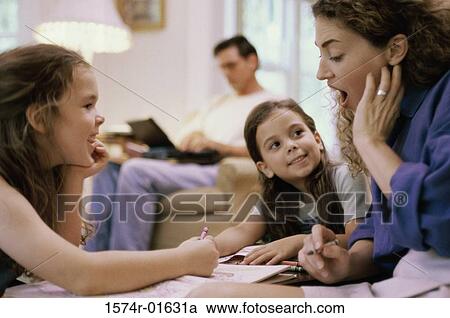 Stock Image - Mother coloring with her two daughters. Fotosearch