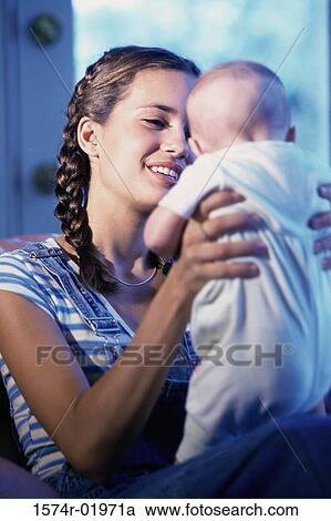 Mother holding her baby boy View Large Photo Image Stock Image - Mother holding her baby boy. Fotosearch