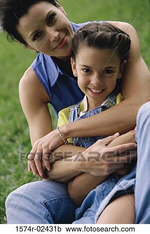 Mother hugging her daughter View Large Photo Image Stock Image - Mother hugging her daughter. Fotosearch