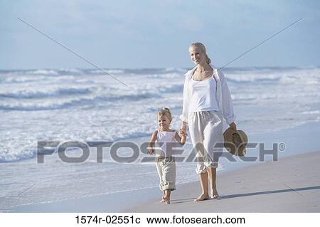 Mother walking with her daughter on the beach View Large Photo Image Stock Image - Mother walking with her daughter on the beach. Fotosearch