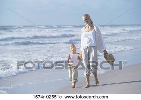 Mother walking with her daughter on the beach View Large Photo Image Stock Image - Mother walking with her daughter on the beach. Fotosearch
