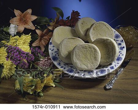 Muffins on a plate next to flowers View Large Photo Image Stock Image - Muffins on a plate next to flowers. Fotosearch