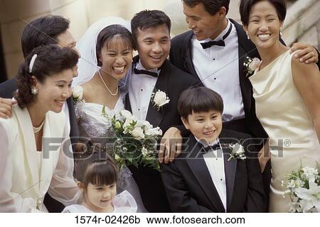 Stock Image - Newlywed couple smiling with their friends. Fotosearch