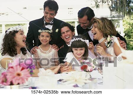 Stock Image - Newlywed couple with bridesmaids and groomsmen. Fotosearch