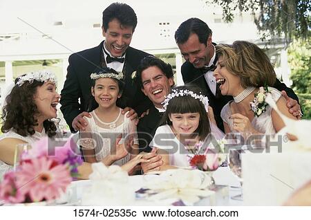 Stock Image - Newlywed couple with bridesmaids and groomsmen. Fotosearch