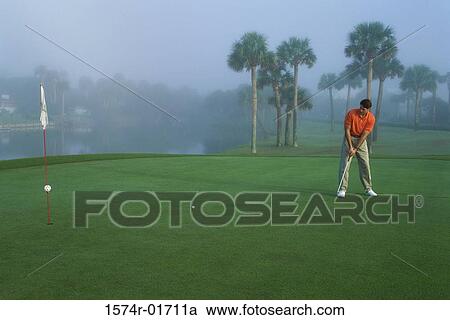 One mid adult man playing golf View Large Photo Image Stock Image - One mid adult man playing golf. Fotosearch