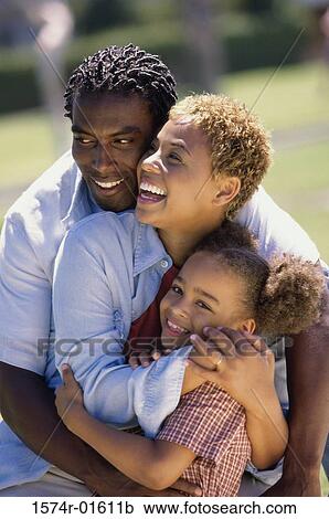 Parents hugging their daughter View Large Photo Image Stock Image - Parents hugging their daughter. Fotosearch
