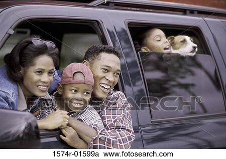 Parents in a car with their two children and a dog View Large Photo Image Stock Image - Parents in a car with their two children and a dog. Fotosearch