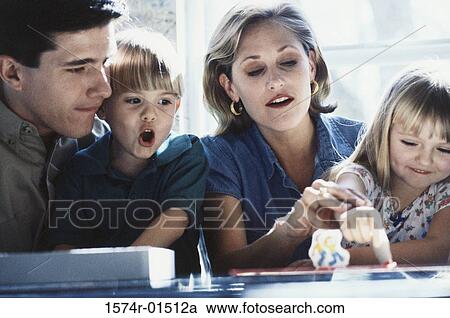 Parents playing a board game with their son and daughter View Large Photo Image Stock Image - Parents playing a board game with their son and daughter. Fotosearch