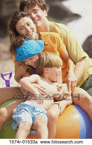 Stock Image - Parents playing with their son and daughter. Fotosearch